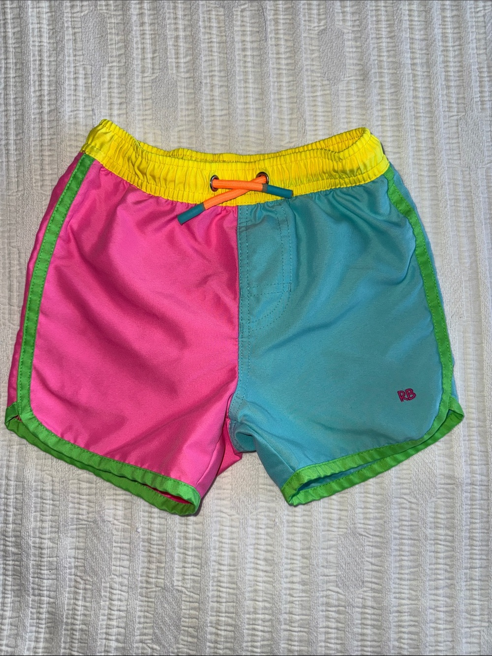 Ruffle Butts Pink & Aqua Colorblock Swim Shorts with Yellow Waist